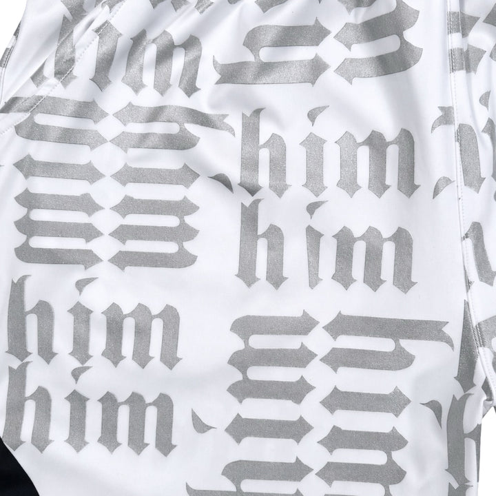 White silver and black him shorts with silver text pattern and black trim closeup