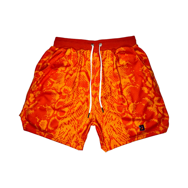 Mamba Elite PRO™ orange basketball shorts featuring a bold snakeskin-inspired pattern, premium MeshX™ construction, oversized PRO waistband, and performance athletic fit designed to match Kobe and Jordan sneakers.