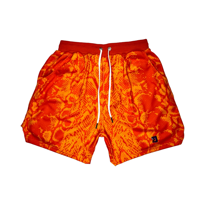 Mamba Elite PRO™ orange basketball shorts featuring a bold snakeskin-inspired pattern, premium MeshX™ construction, oversized PRO waistband, and performance athletic fit designed to match Kobe and Jordan sneakers.