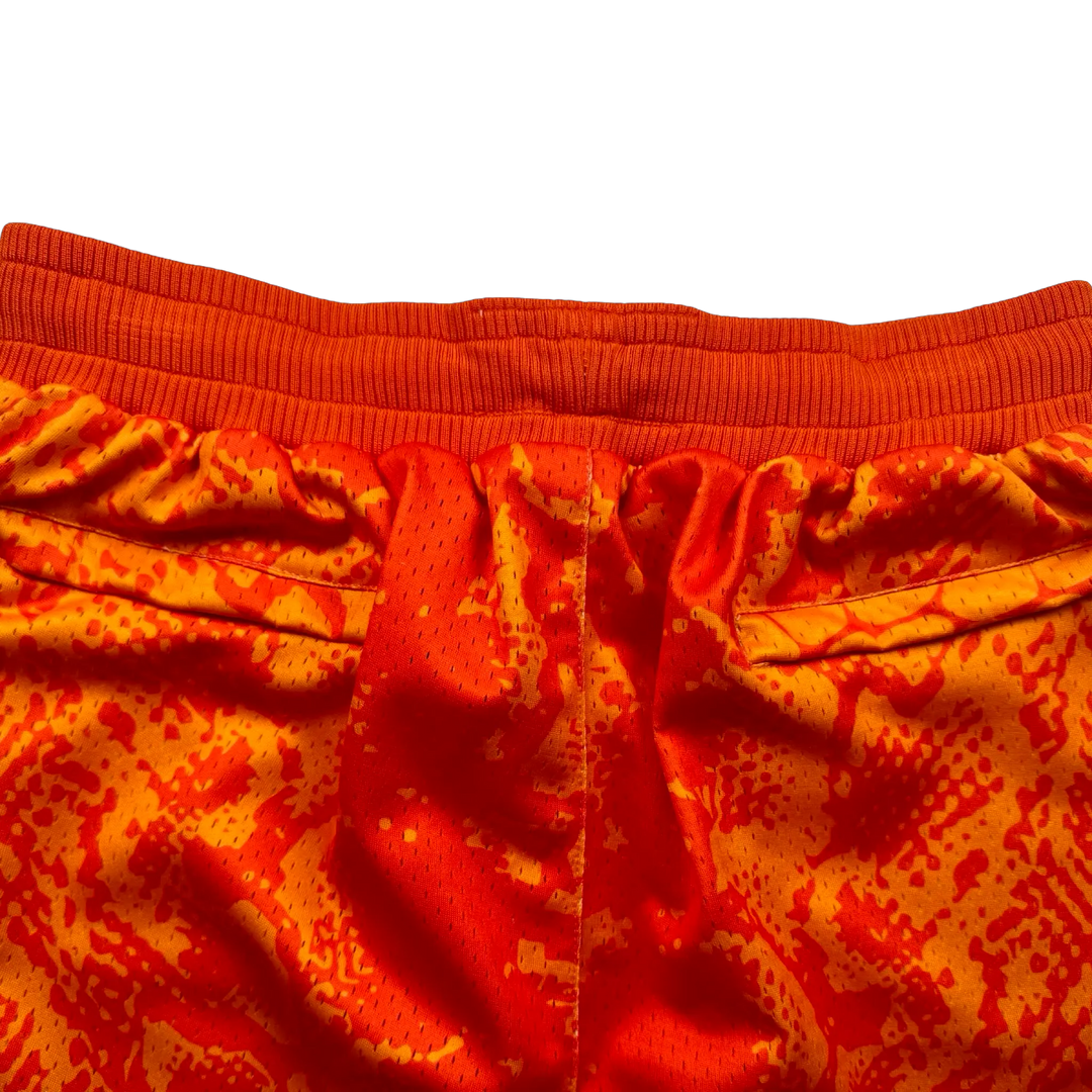 Mamba Elite PRO™ orange basketball shorts featuring a bold snakeskin-inspired pattern, premium MeshX™ construction, oversized PRO waistband, and performance athletic fit designed to match Kobe and Jordan sneakers.