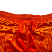 Mamba Elite PRO™ orange basketball shorts featuring a bold snakeskin-inspired pattern, premium MeshX™ construction, oversized PRO waistband, and performance athletic fit designed to match Kobe and Jordan sneakers.