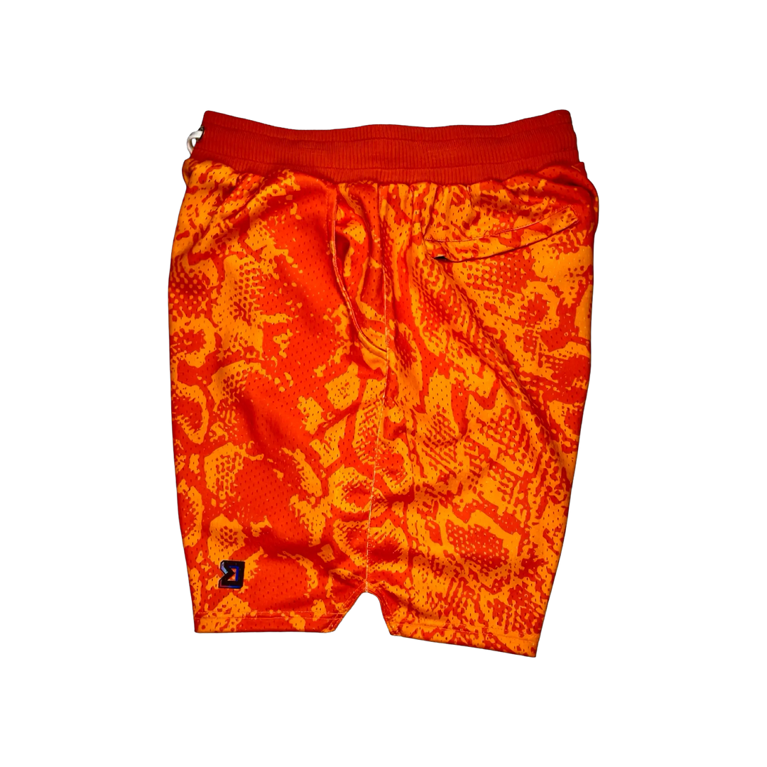 Mamba Elite PRO™ orange basketball shorts featuring a bold snakeskin-inspired pattern, premium MeshX™ construction, oversized PRO waistband, and performance athletic fit designed to match Kobe and Jordan sneakers.