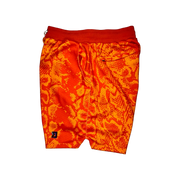 Mamba Elite PRO™ orange basketball shorts featuring a bold snakeskin-inspired pattern, premium MeshX™ construction, oversized PRO waistband, and performance athletic fit designed to match Kobe and Jordan sneakers.
