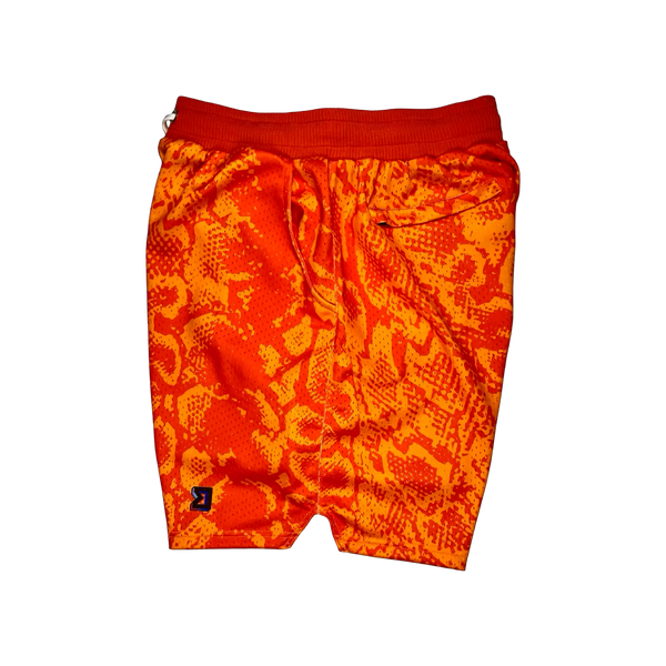 Mamba Elite PRO™ orange basketball shorts featuring a bold snakeskin-inspired pattern, premium MeshX™ construction, oversized PRO waistband, and performance athletic fit designed to match Kobe and Jordan sneakers.