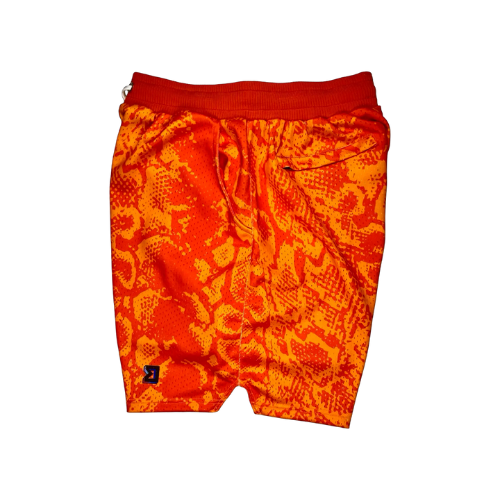 Mamba Elite PRO™ orange basketball shorts featuring a bold snakeskin-inspired pattern, premium MeshX™ construction, oversized PRO waistband, and performance athletic fit designed to match Kobe and Jordan sneakers.