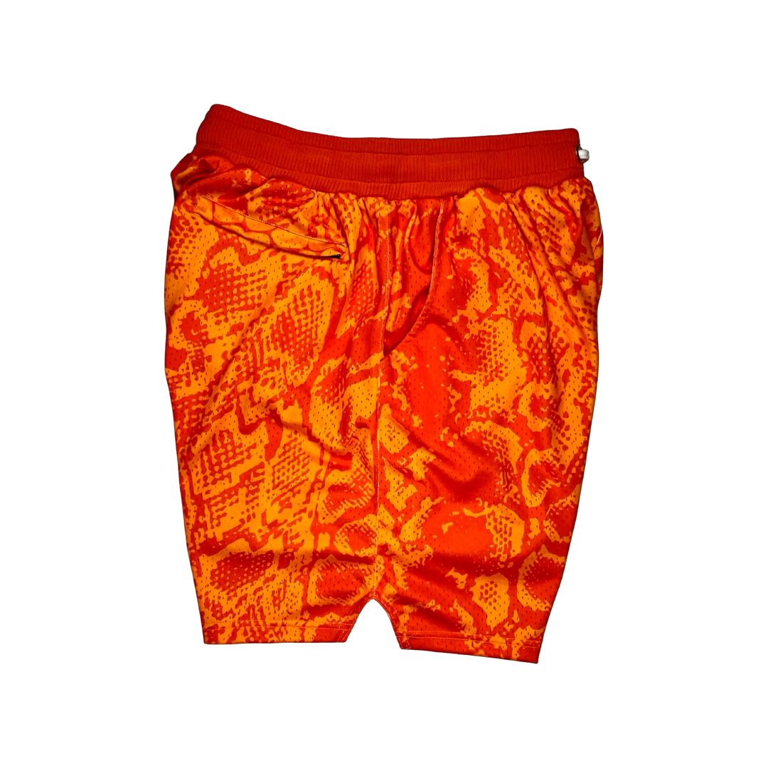 Mamba Elite PRO™ orange basketball shorts featuring a bold snakeskin-inspired pattern, premium MeshX™ construction, oversized PRO waistband, and performance athletic fit designed to match Kobe and Jordan sneakers.