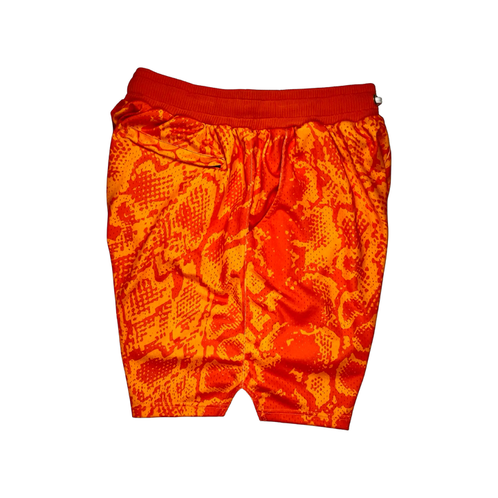 Mamba Elite PRO™ orange basketball shorts featuring a bold snakeskin-inspired pattern, premium MeshX™ construction, oversized PRO waistband, and performance athletic fit designed to match Kobe and Jordan sneakers.