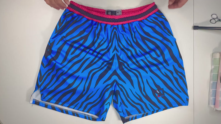 Blue Rave Zebra Soft Quick-Dry basketball shorts with neon blue zebra stripes and hot-pink sides. Lightweight, breathable, above-knee fit.