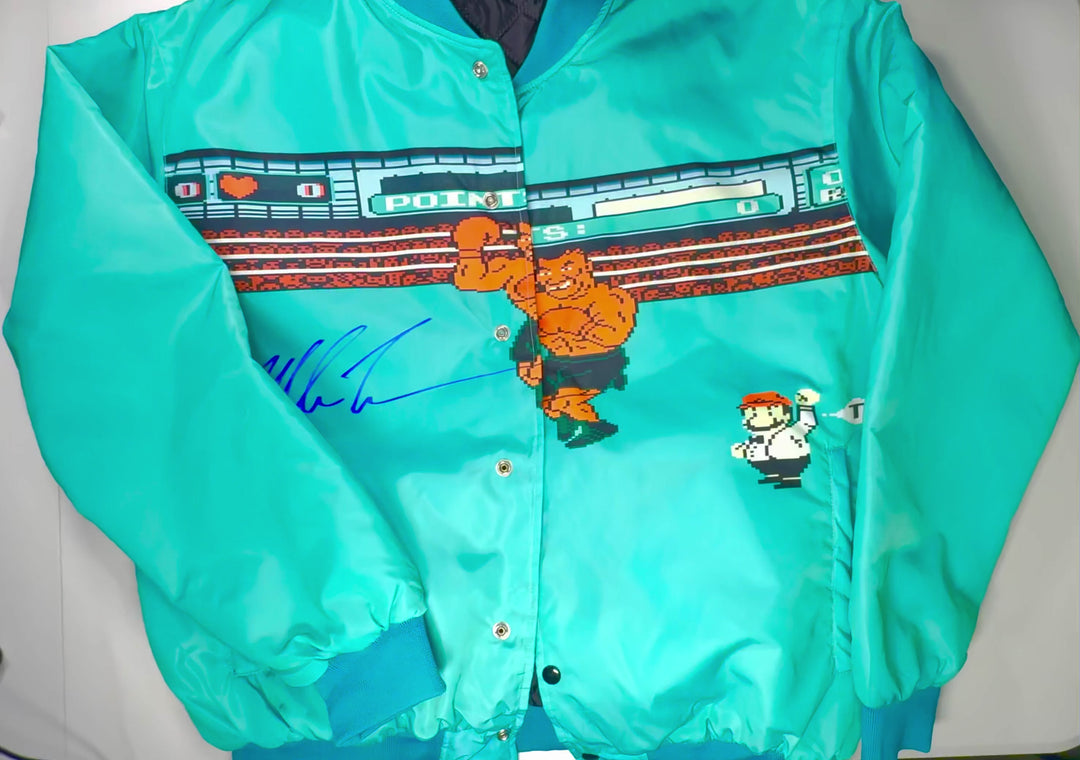 Light blue satin “Punched Out” jacket featuring 8-bit boxing artwork, snap-button closure, ribbed cuffs/neck, and front + inside pockets by Trap’N.