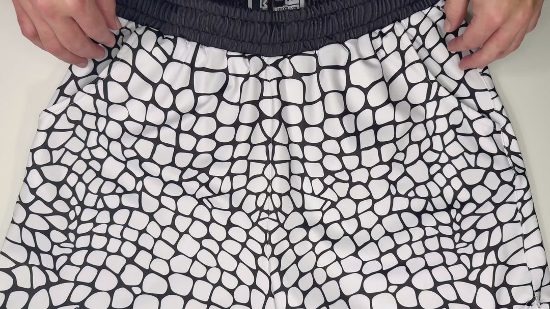 Yt Fang Soft Quick-Dry basketball shorts in white and black reptile-scale pattern with above-knee cut and signature Trap’N Shorts logo.