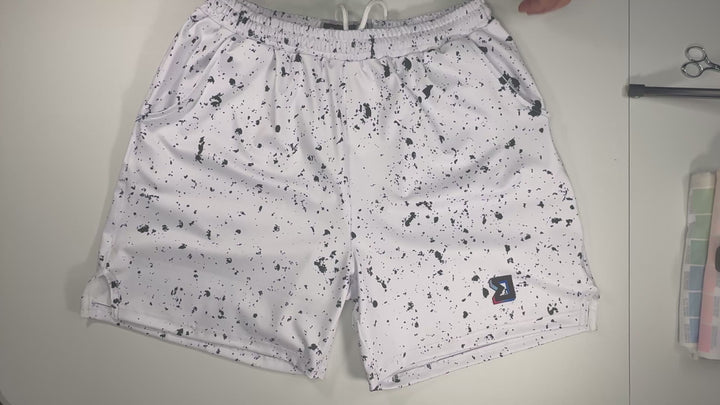 Speckle Soft QD basketball shorts with white/black splatter design. Lightweight, smooth, moisture-wicking  by Trap’N Shorts.