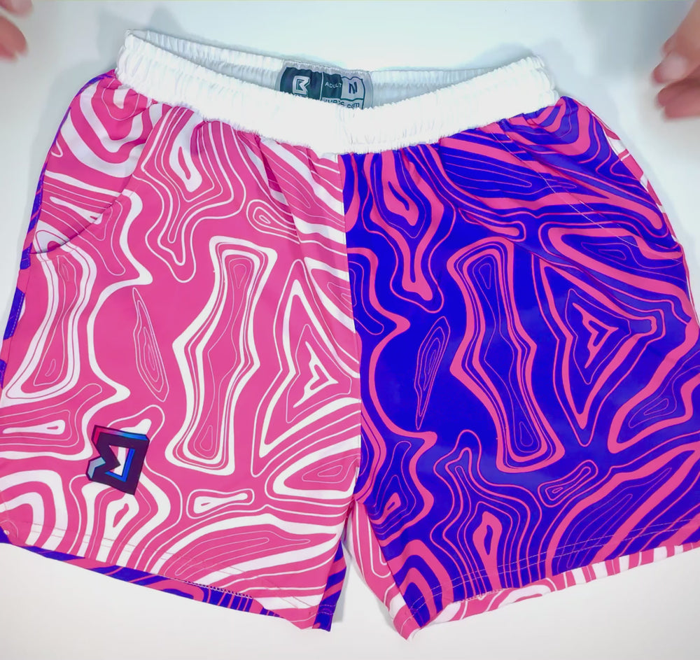 Swirl GO basketball shorts with split pink and blue wave-style artwork by Trap’N Shorts.