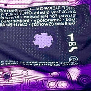 Close-up of a purple cassette tape with text and symbols