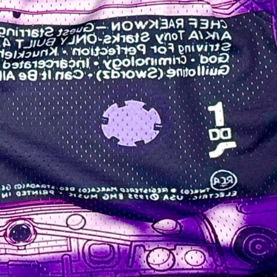 Close-up of a purple cassette tape with text and symbols