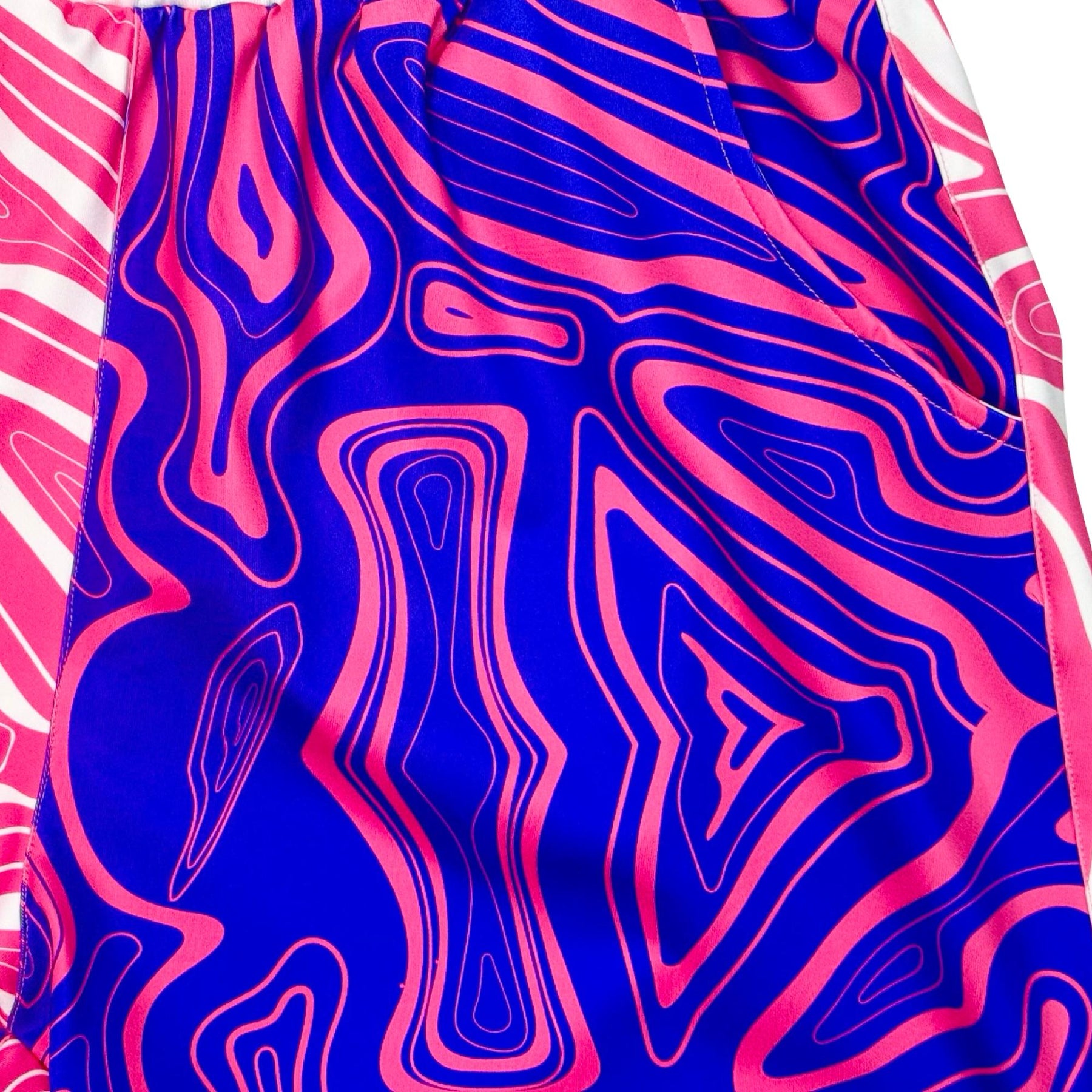Pair of two-tone shorts with pink and purple swirl pattern texture closeup 