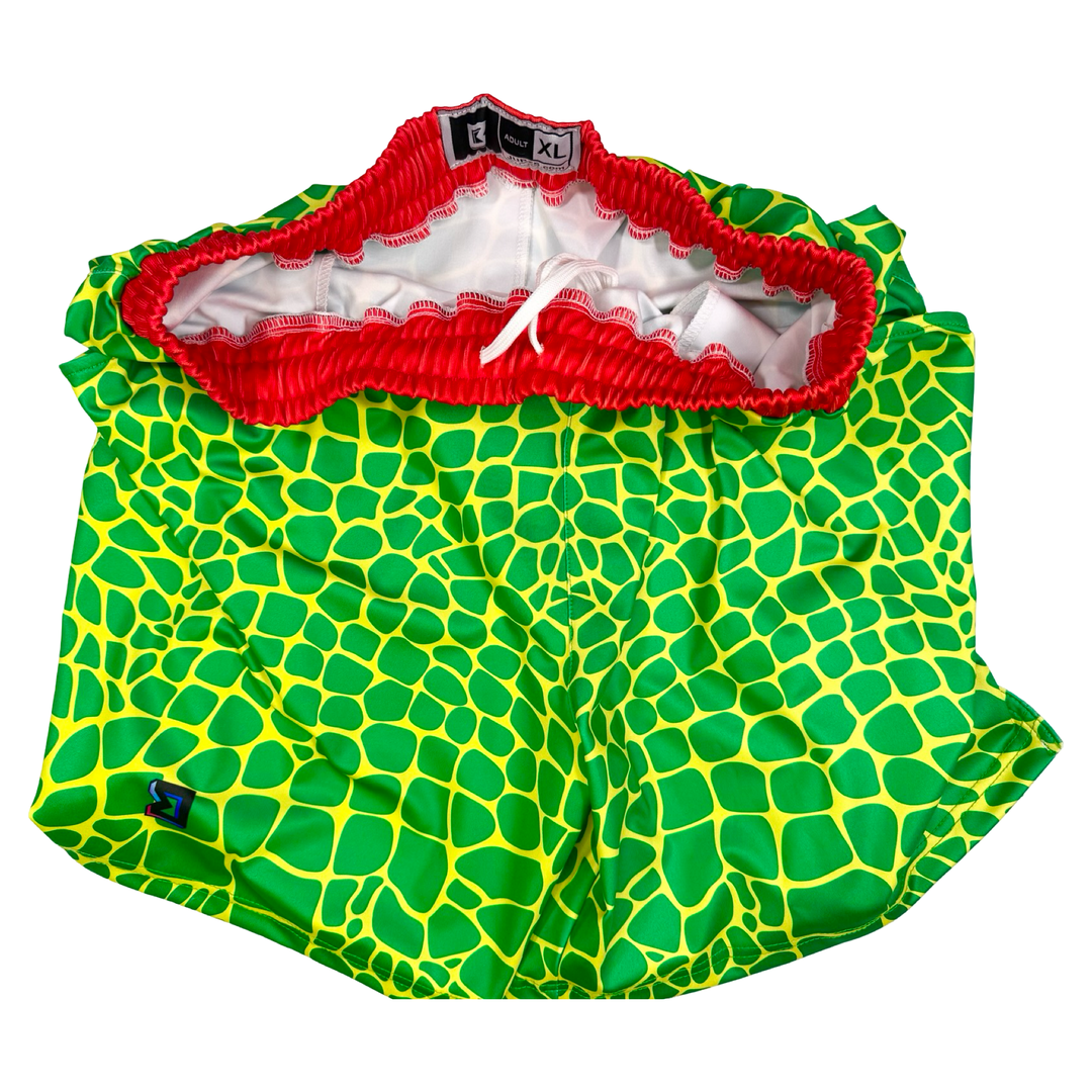 Trap Zombie Soft Quick-Dry basketball shorts in green reptile-scale pattern with red waistband, above-knee cut, and signature Trap’N Shorts logo.