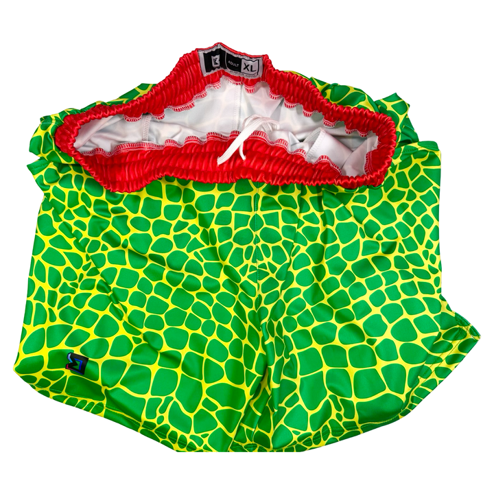 Trap Zombie Soft Quick-Dry basketball shorts in green reptile-scale pattern with red waistband, above-knee cut, and signature Trap’N Shorts logo.