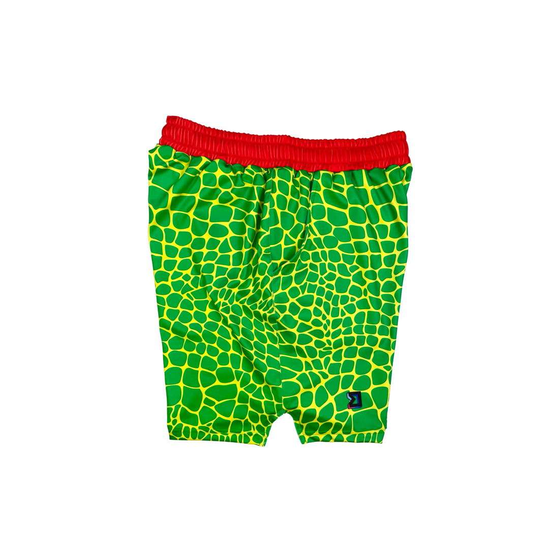 Trap Zombie Soft Quick-Dry basketball shorts in green reptile-scale pattern with red waistband, above-knee cut, and signature Trap’N Shorts logo.
