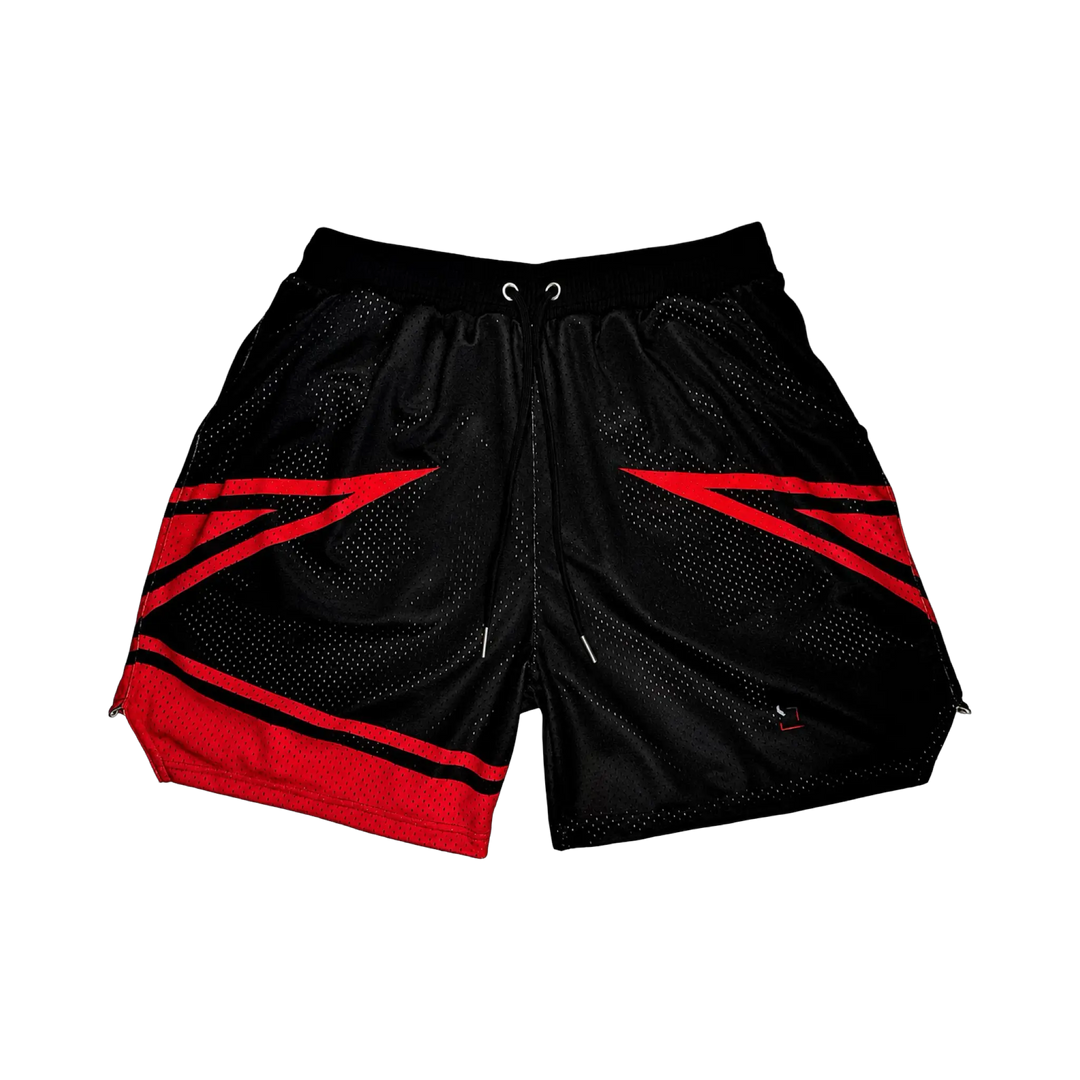 Wildcat Elite PRO™ red basketball shorts featuring bold angular red paneling, premium MeshX™ construction, oversized PRO waistband, and performance athletic fit designed to match Jordan Bred and Nike basketball sneakers.