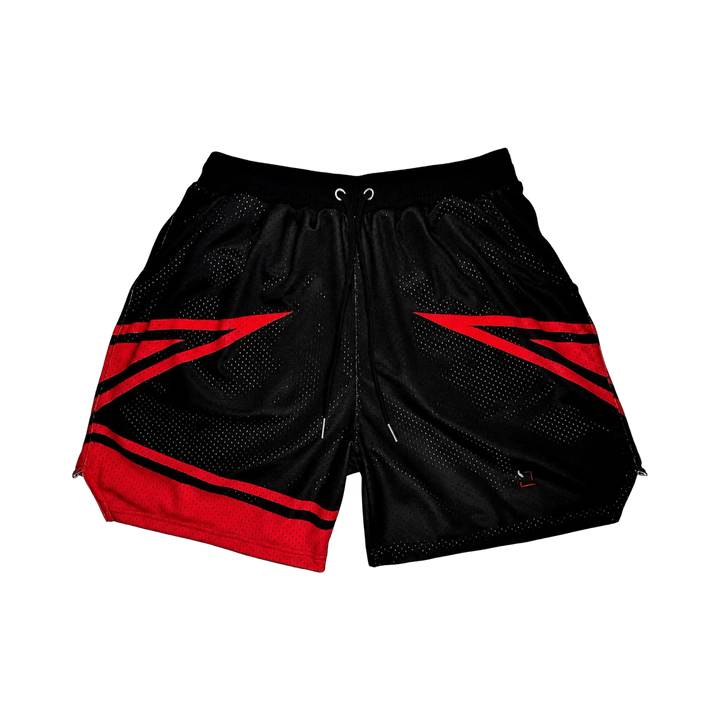 Wildcat Elite PRO™ red basketball shorts featuring bold angular red paneling, premium MeshX™ construction, oversized PRO waistband, and performance athletic fit designed to match Jordan Bred and Nike basketball sneakers.